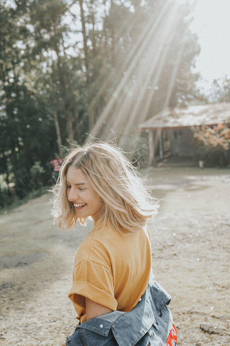 blonde woman laugh in the sun 