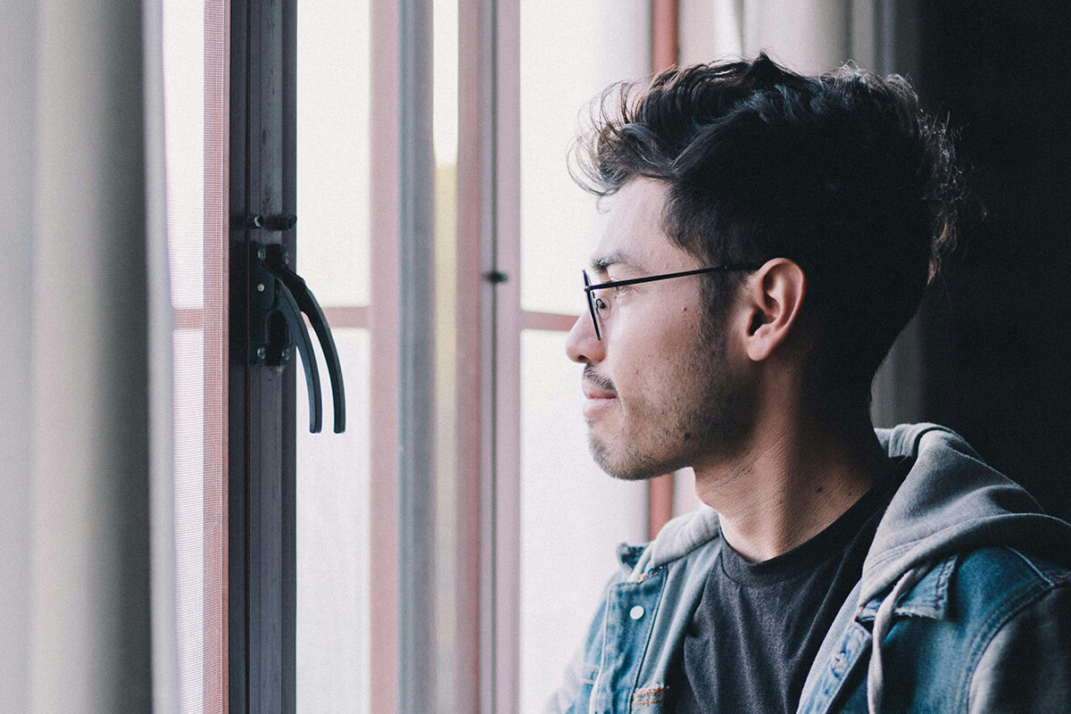 A man looking out a window