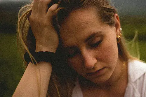 hands-through-hair A woman running her hands through her hair