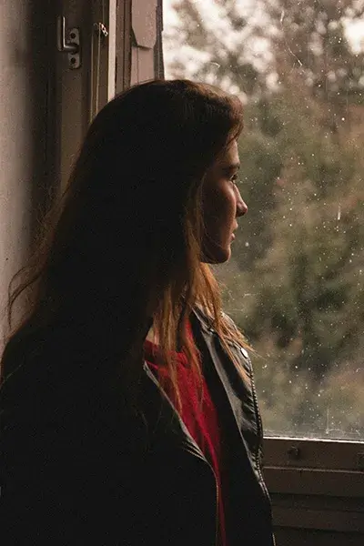 woman-looking-out-her-window A woman with OCD looking out her window