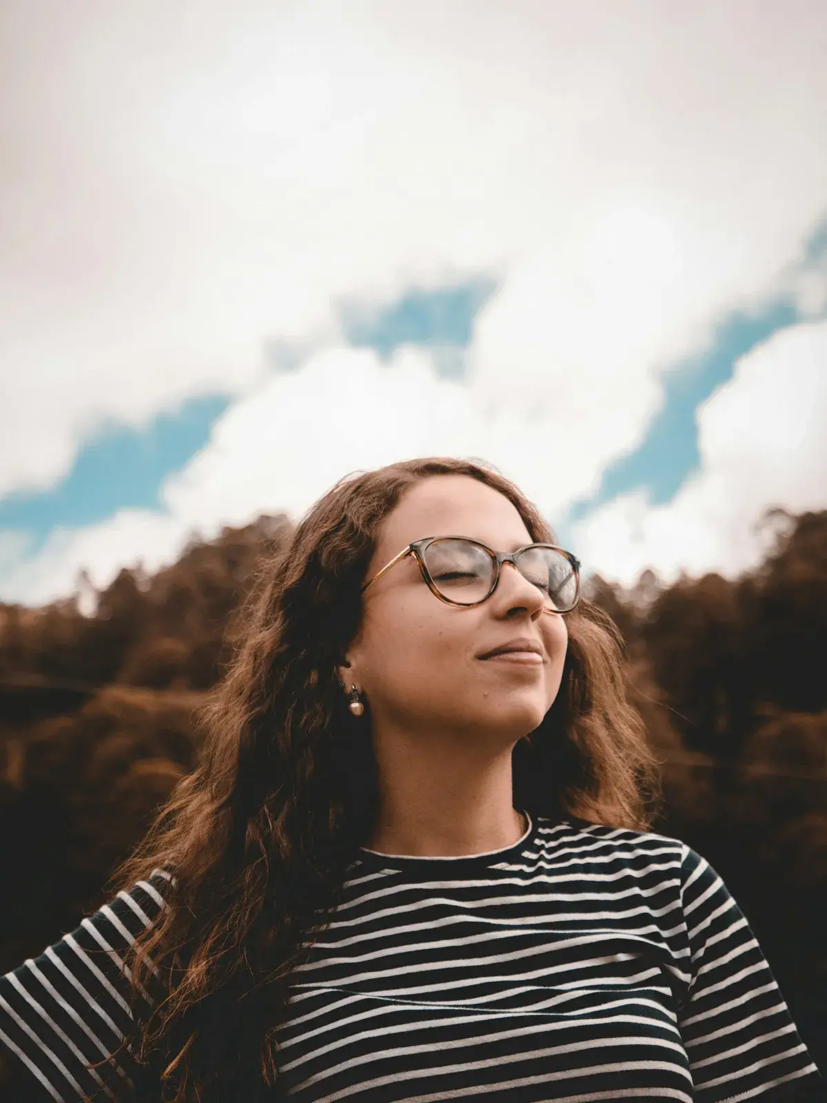 woman-smiling-with-eyes-closed A woman softly smiling with her eyes closed