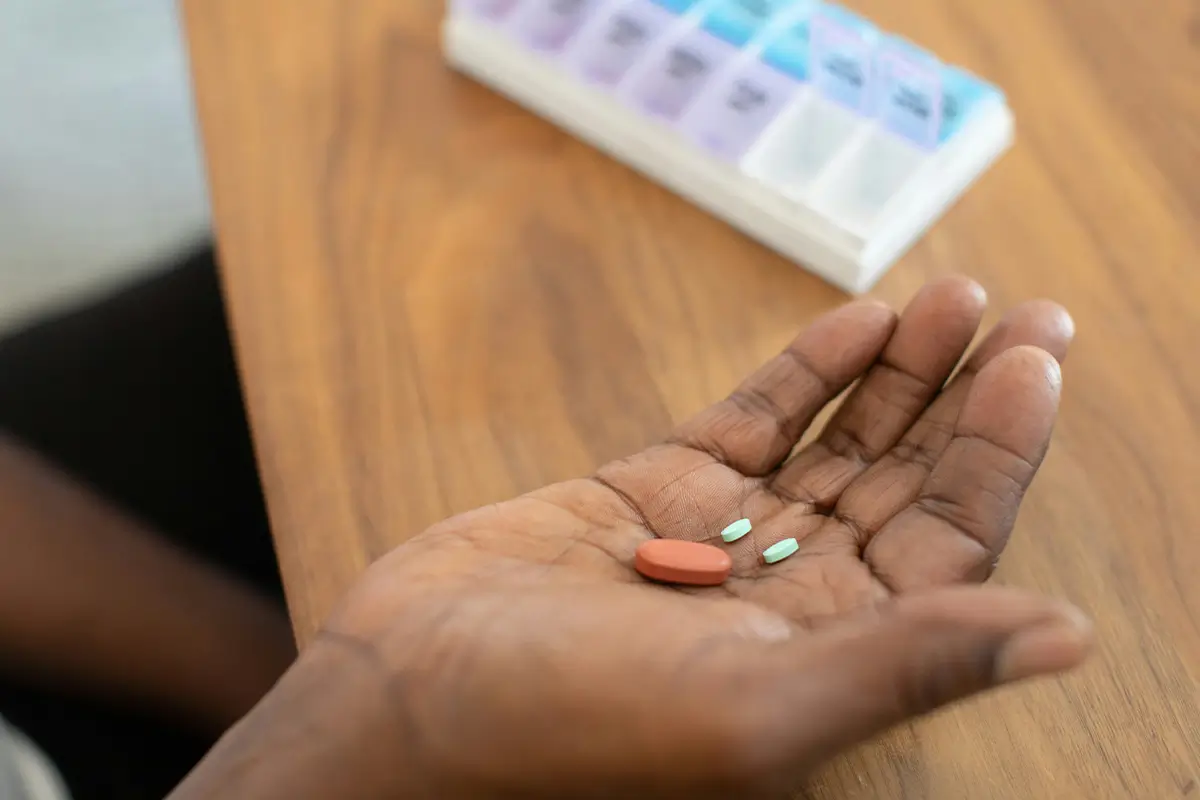 What Medications Are Used to Treat Bipolar Disorder? Person holding bipolar disorder medications in hand