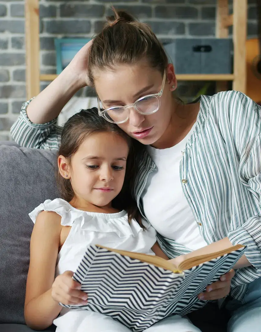 Woman reading with daughter